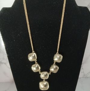 Gold tone statement necklace with square charm design